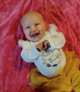 Smiling 2-month-old Cass